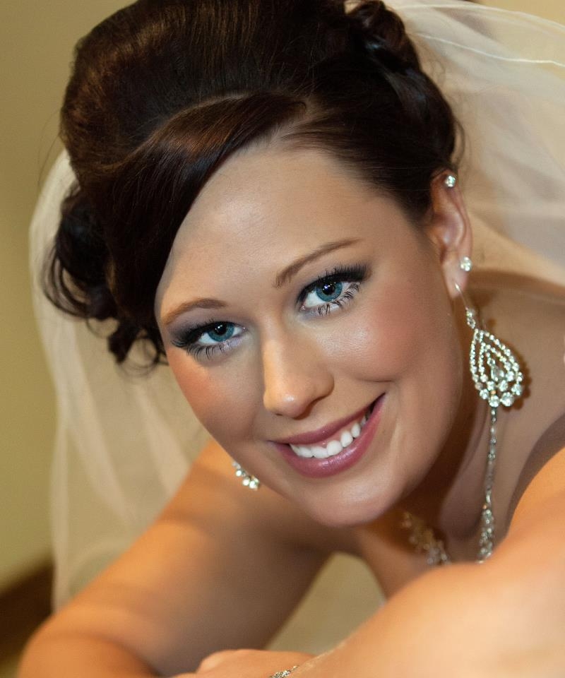 Woman with captivating blue eyes and perfectly kept hair sports wedding veil