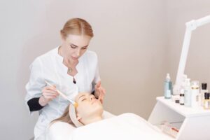 a female esthetician doing a facial on a female client