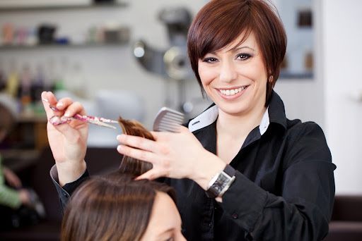 Stylist smiling while cutting hair