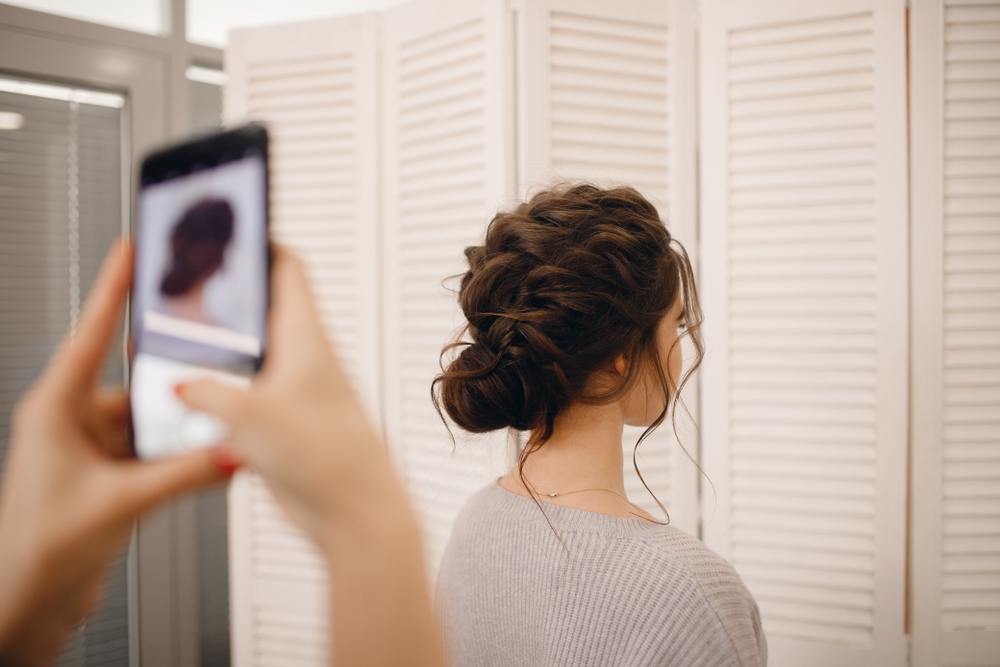 hairstylist taking client's photo