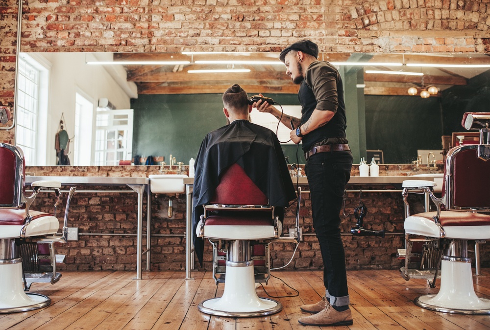 barber shaving a client's hair