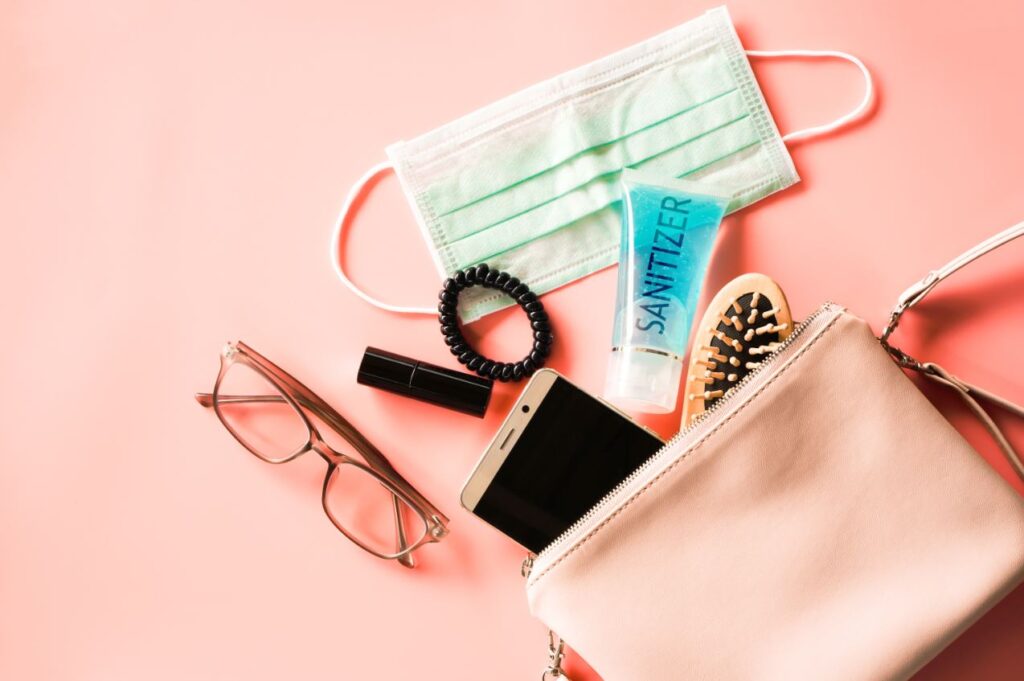 purse with brush, sanitizer, and mask